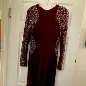 Floor length long sleeve burgundy gown. Excellent pre-owned condition.